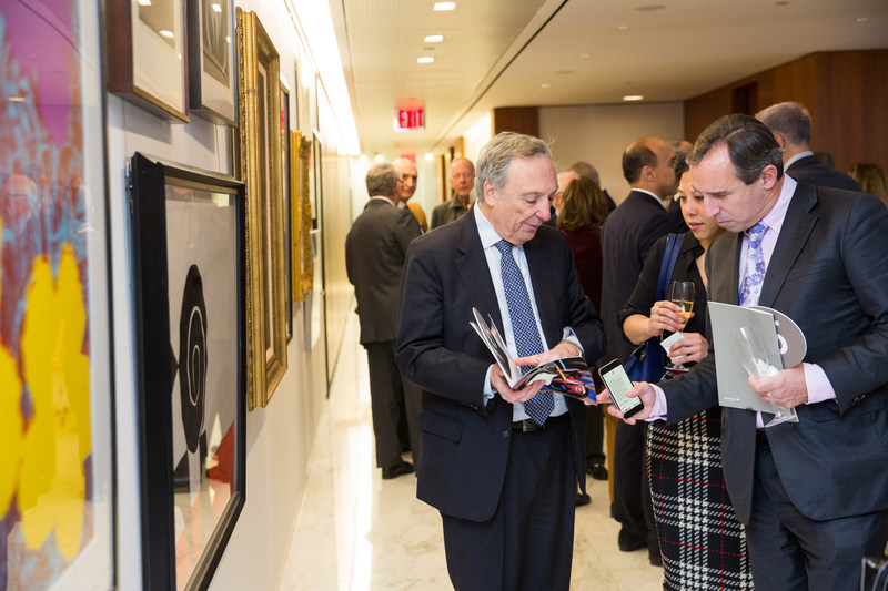Dr. Charles R. Marmar, Dr. John Golfinos, and Dr. Koto Ishida browse artwork from Andy Warhol, Norman Rockwell, and David Hockney, among others. Dr. Charles R. Marmar, Dr. John Golfinos, and Dr. Koto Ishida browse artwork from Andy Warhol, Norman Rockwell, and David Hockney, among others.